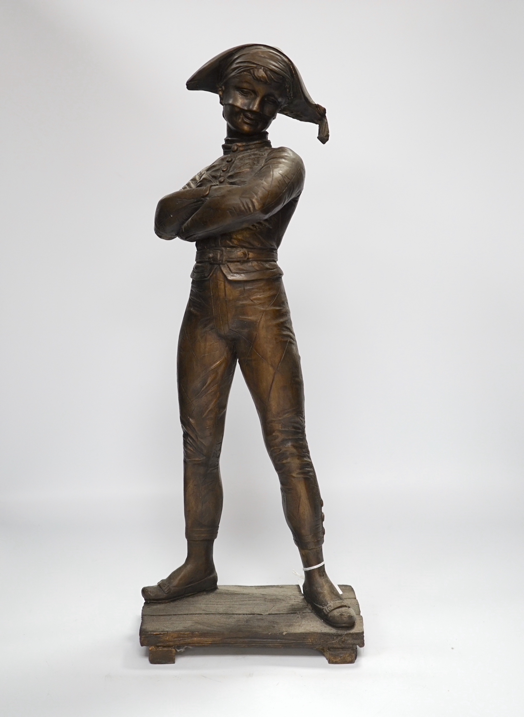 A tall bronze figure of harlequin, 52cm high